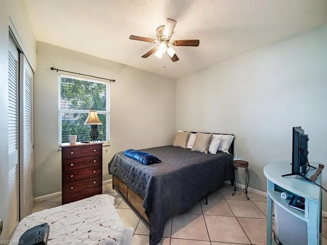 Bedroom featuring ceiling fan and light tile floors