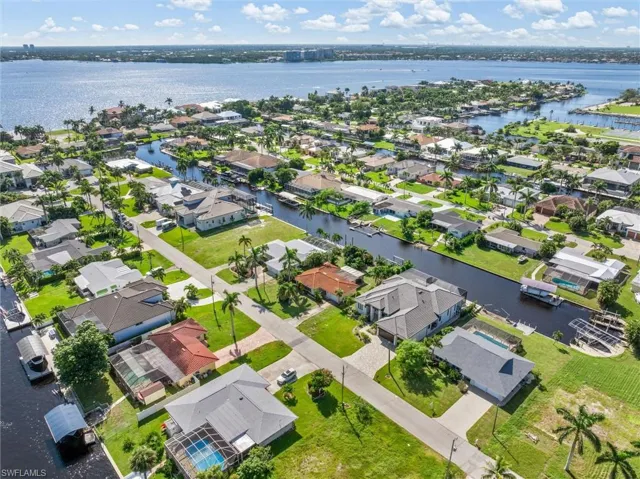 Aerial view of residential area featuring a large body of water