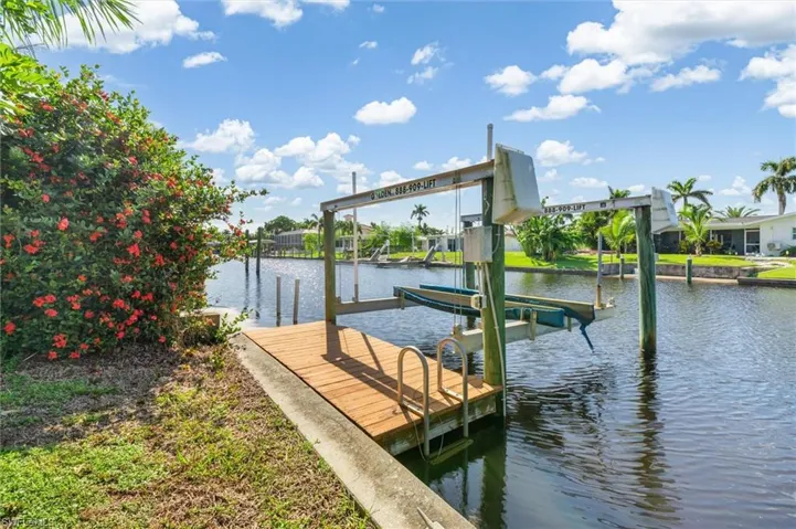 Dock area featuring a water view and boat lift