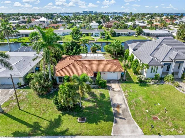 Aerial view of residential area featuring a large body of water