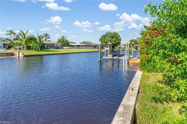 Dock with boat lift and a water view