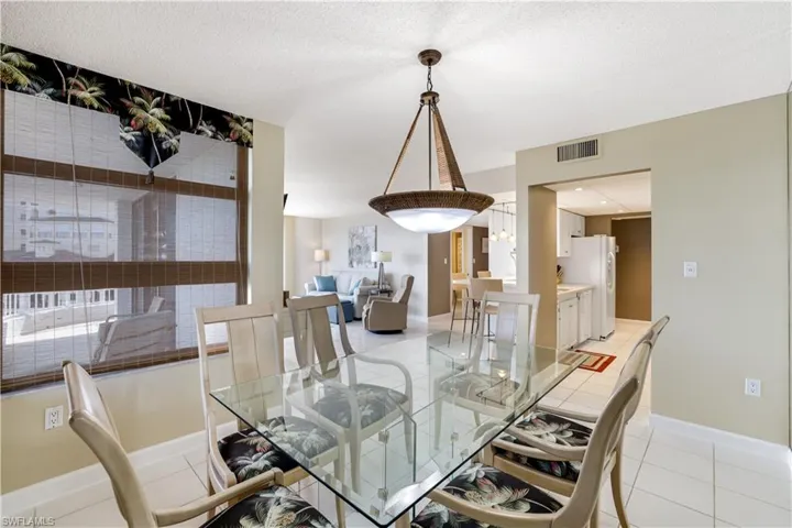 Dining room featuring light tile patterned floors and a textured ceiling