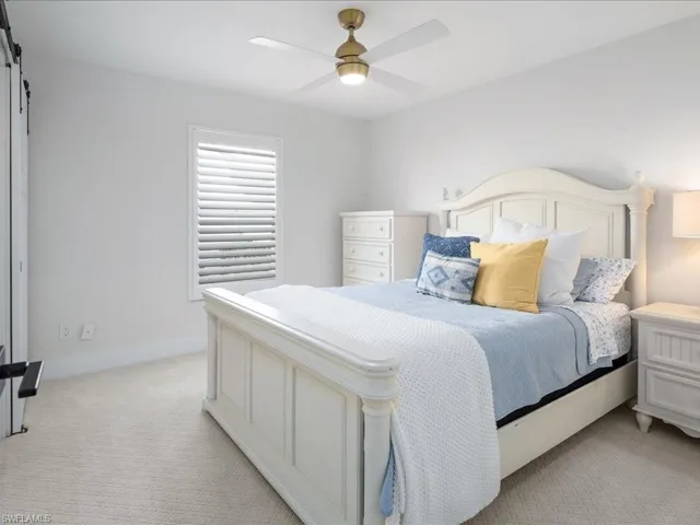 Bedroom featuring light carpet and ceiling fan