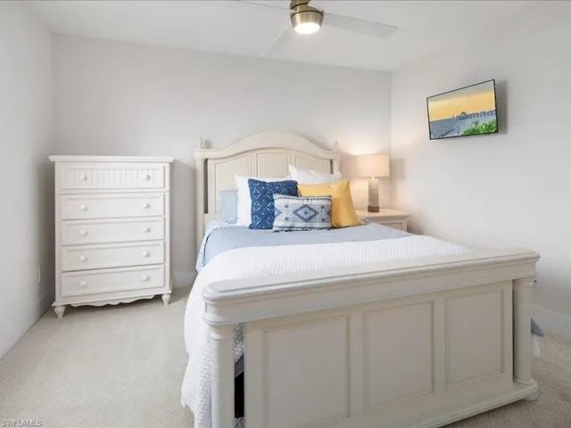 Bedroom featuring light colored carpet and ceiling fan