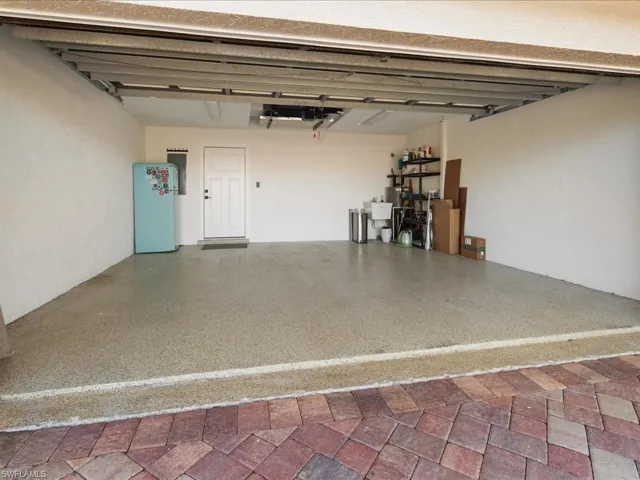 Garage featuring white fridge