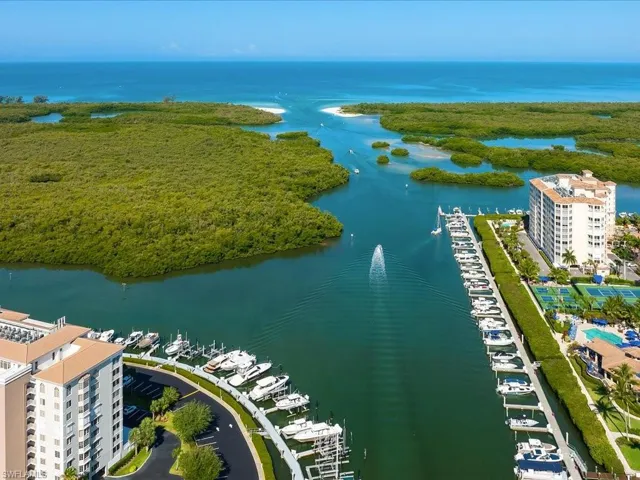 Birds eye view of property with a water view