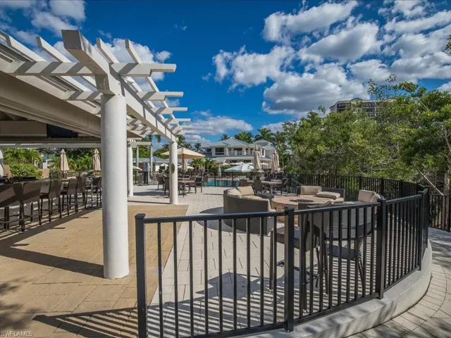 View of patio with a pergola and a community pool