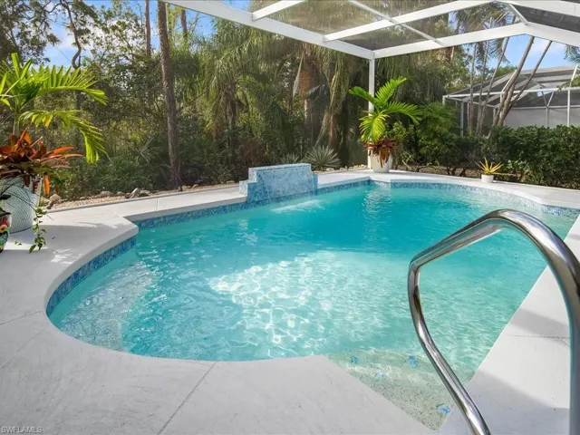 View of pool featuring pool water feature and a lanai