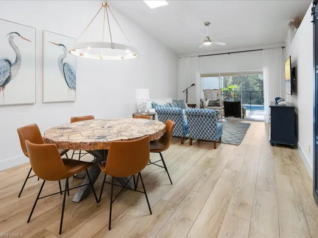 Dining space with ceiling fan and light hardwood / wood-style floors
