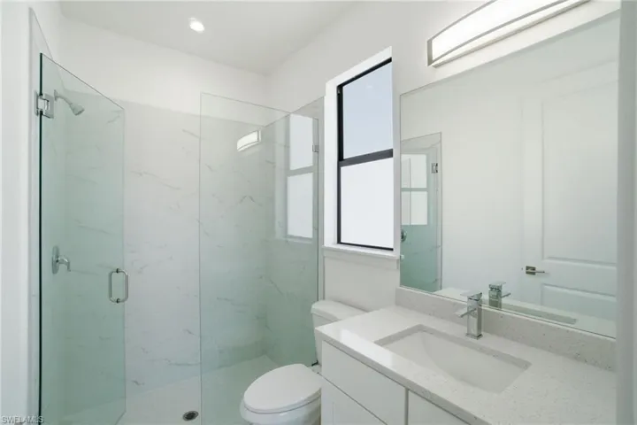 Full bathroom with vanity and a marble finish shower