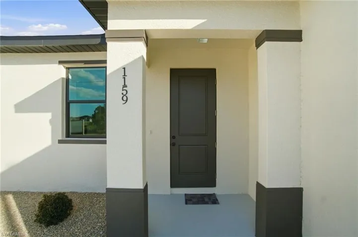 View of exterior entry featuring stucco siding