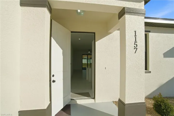 Entrance to property featuring stucco siding
