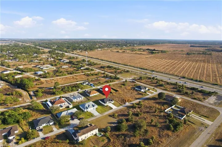 Aerial overview of property's location with rural landscape and nearby suburban area