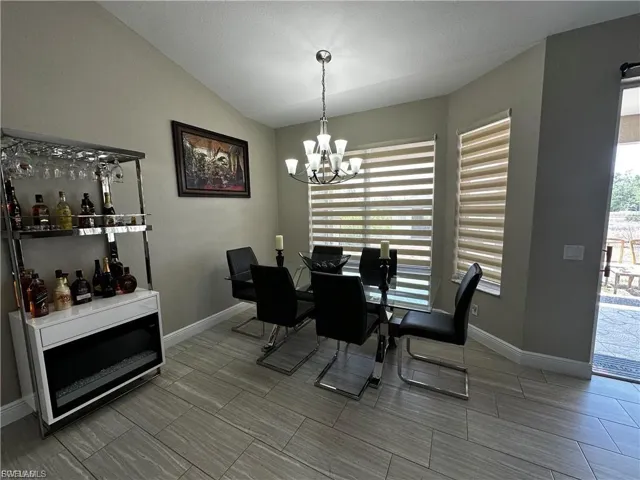 Dining room with lofted ceiling and a chandelier