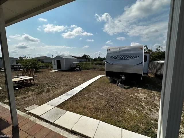 View of yard featuring a storage unit