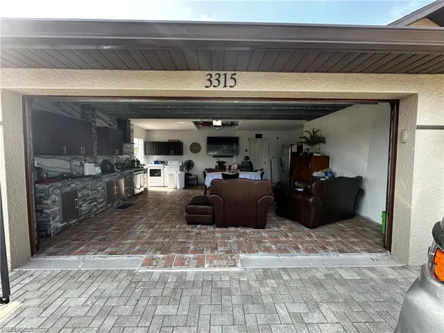 View of patio featuring washer / dryer and a garage