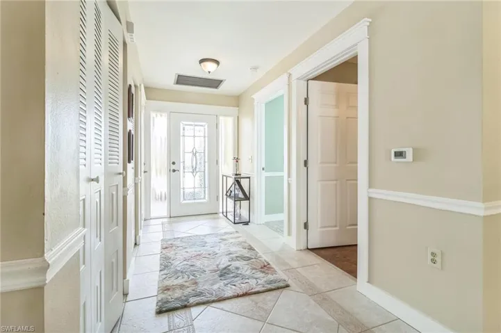 Foyer entrance with light tile patterned floors