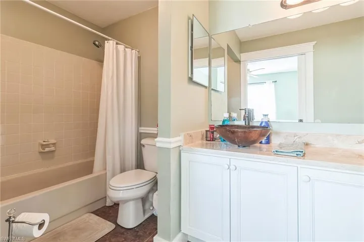 Full bathroom featuring toilet, vanity, tile patterned flooring, and shower / bathtub combination with curtain