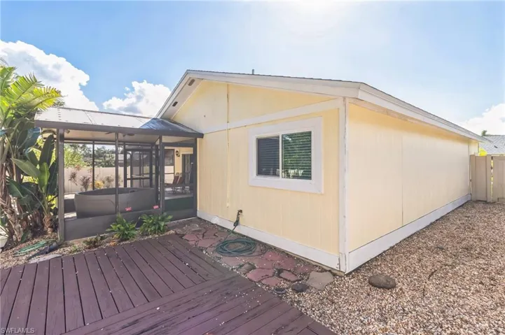 Wooden deck featuring a sunroom