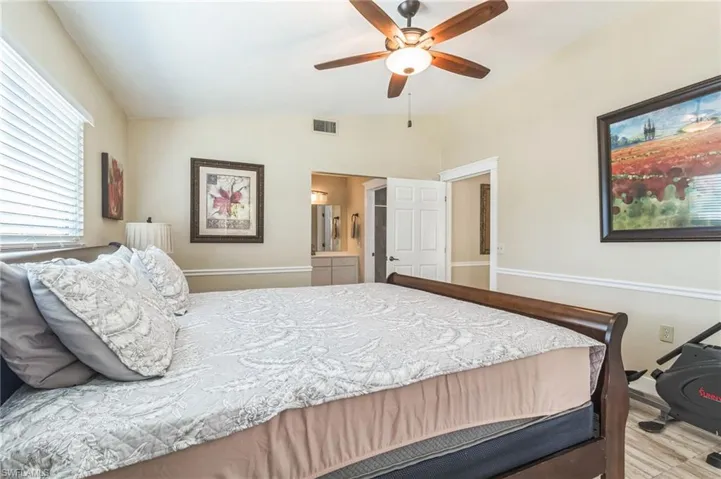 Bedroom with vaulted ceiling and ceiling fan