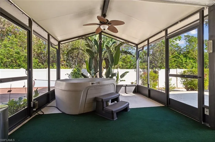Unfurnished sunroom featuring vaulted ceiling and a healthy amount of sunlight