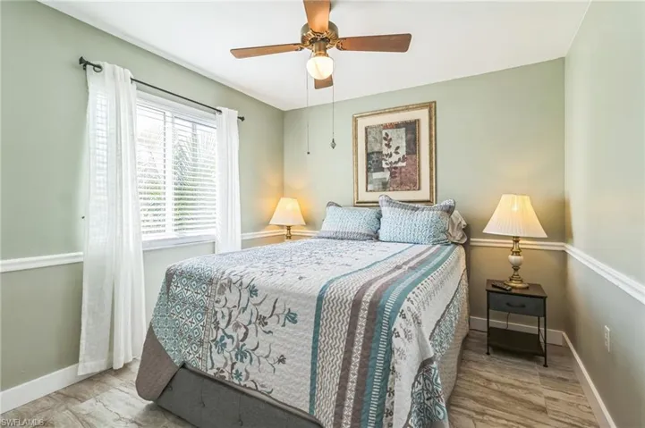 Bedroom featuring wood-type flooring and ceiling fan