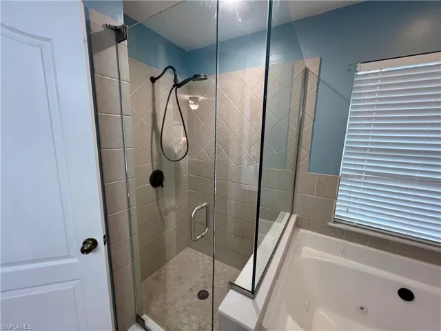 Frameless glass enclosed shower.