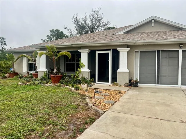 Single story home with a front lawn and a garage