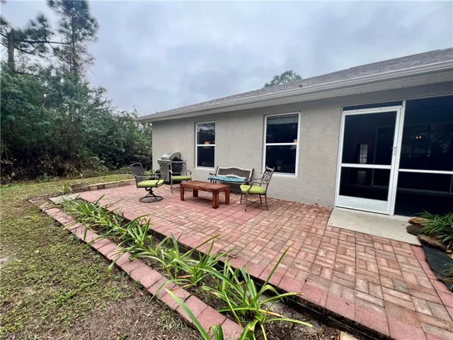 View of patio featuring a grill