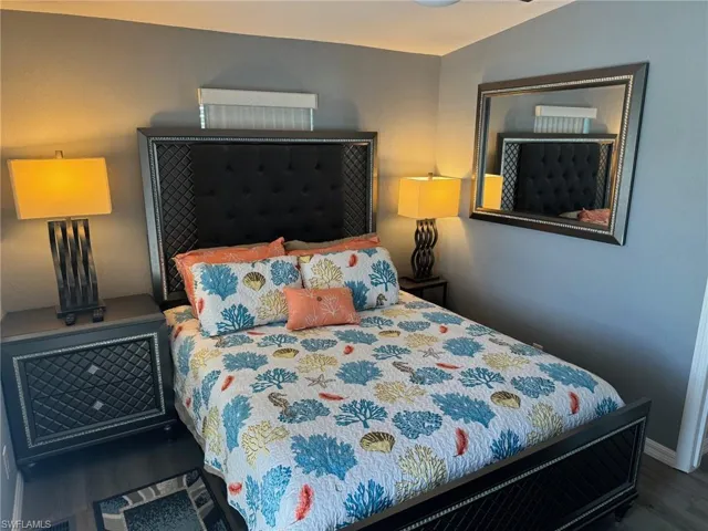 Bedroom with vaulted ceiling and dark hardwood / wood-style flooring