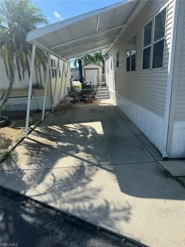 View of parking / parking lot featuring a carport