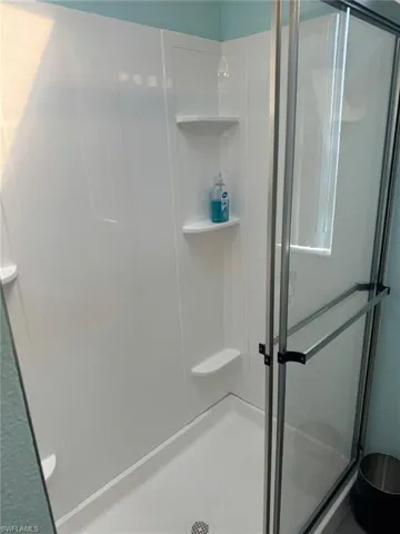 Bathroom featuring a shower with door