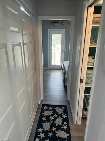 Hall featuring wood-style luxury vinyl flooring