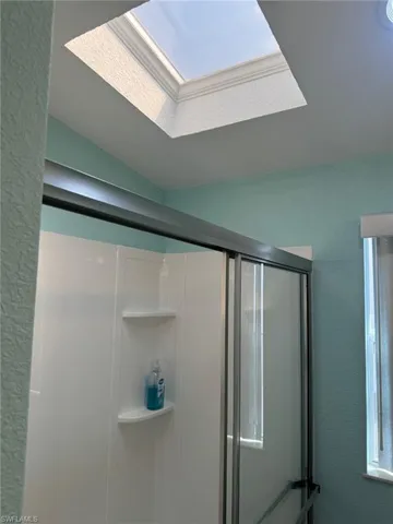 Details with a shower with shower door and skylight in both baths.