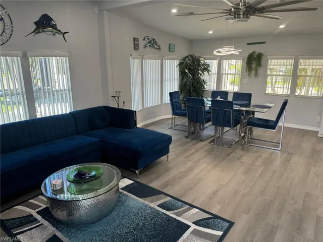 Living room with ceiling fan and hardwood / wood-style floors
