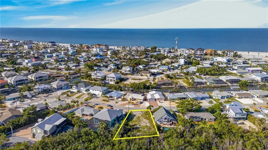 Cleared building lot outlined in yellow, surrounded by mature trees - Virtually Edited Image