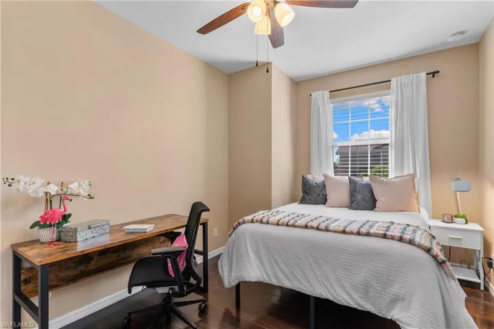 Neutral wall paint, wood-finish flooring, and a ceiling fan with integrated lighting