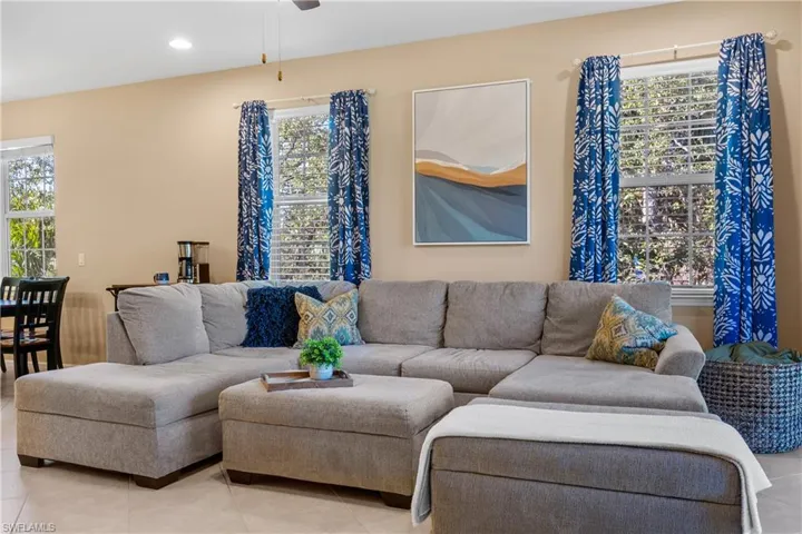 Open-concept living area with light beige wall paint and recessed ceiling lighting