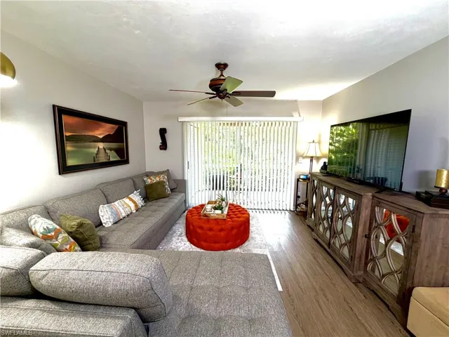 Living area featuring wood finished floors and ceiling fan