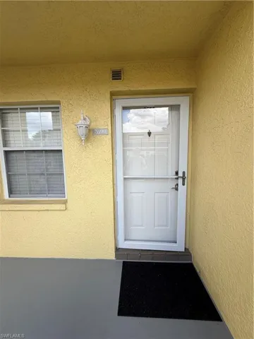 Entrance to property featuring stucco siding
