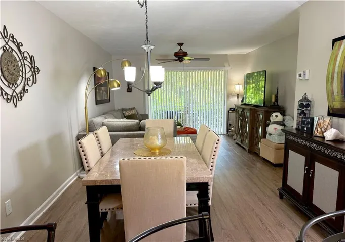 Dining area featuring wood finished floors, a ceiling fan, and hanging lights
