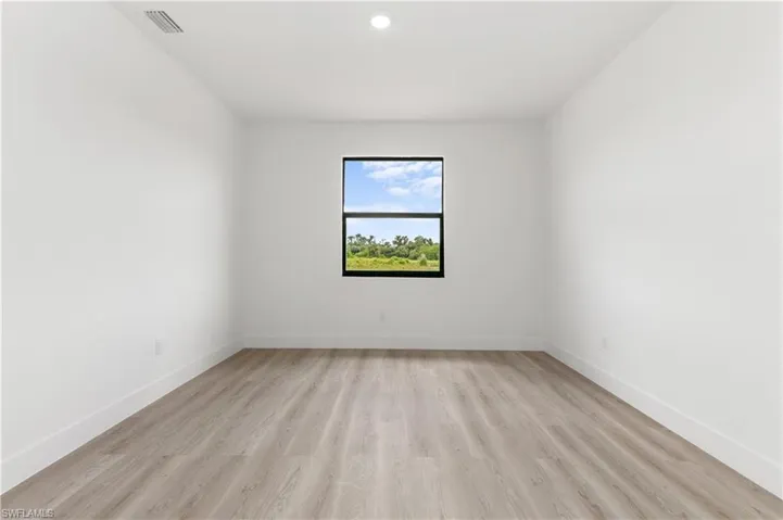 Unfurnished room featuring light wood-type flooring