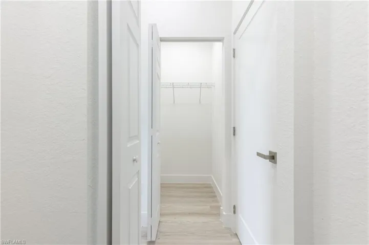 Corridor with light wood-type flooring