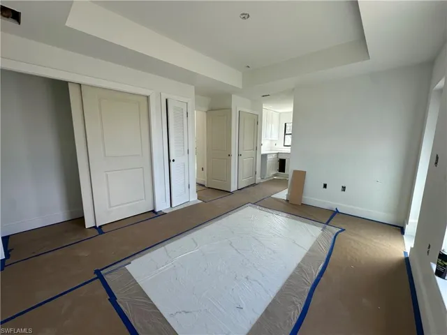 Tray ceiling, multi-panel doors, and neutral wall tones