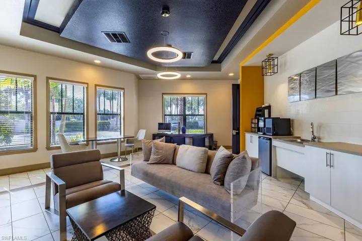 Community lobby featuring a tray ceiling and recessed lighting