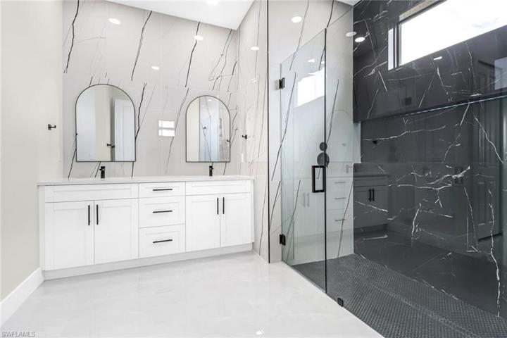 Dual Sinks, Frameless Shower Door and Rain Showerhead