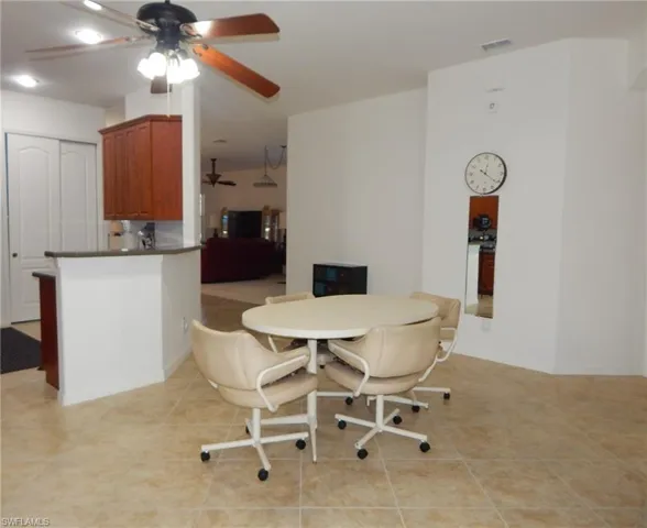Tiled dining area featuring ceiling fan