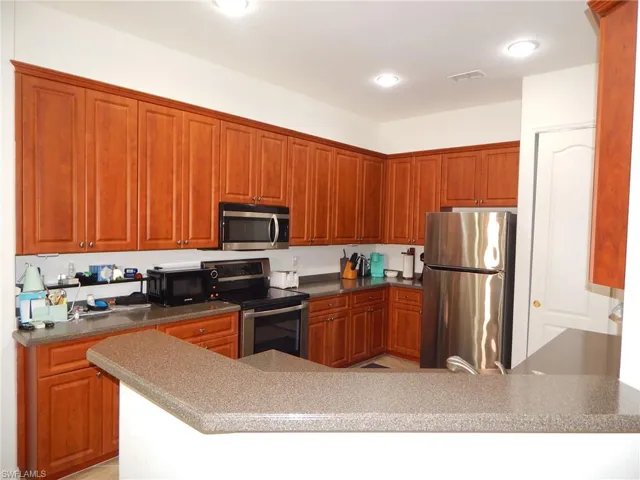 Kitchen featuring appliances with stainless steel finishes and kitchen peninsula