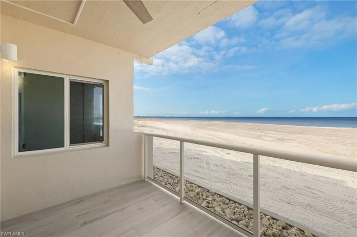 Balcony with view of water and beach