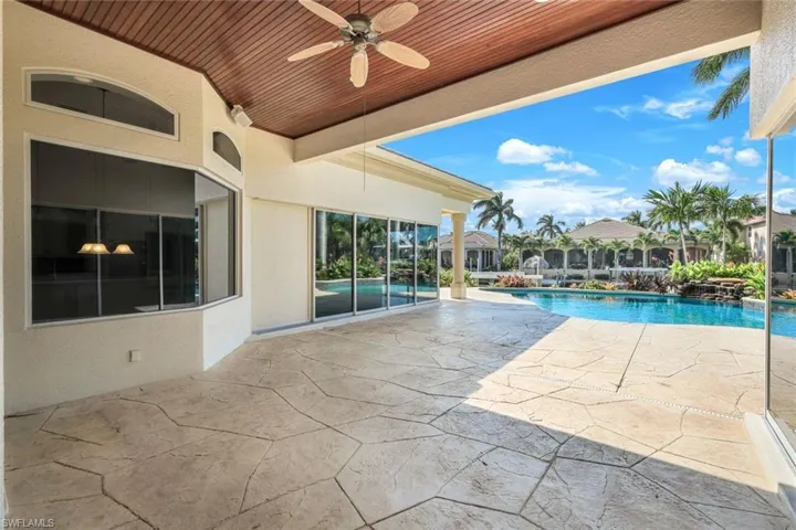 View of swimming pool with a patio area and ceiling fan